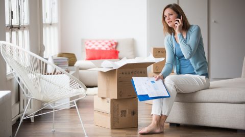 Woman carrying moving boxes in her new home. Paris, France GARO/PHANIE