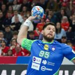 23 January 2024, Hamburg: Handball: European Championship, Slovenia - Denmark, Main Round, Group 2, Matchday 4, Barclaycard Arena. Slovenia's Matic Suholeznik (r) takes a shot. Photo: Christian Charisius/dpa