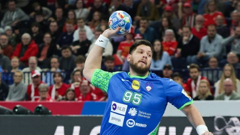 23 January 2024, Hamburg: Handball: European Championship, Slovenia - Denmark, Main Round, Group 2, Matchday 4, Barclaycard Arena. Slovenia's Matic Suholeznik (r) takes a shot. Photo: Christian Charisius/dpa