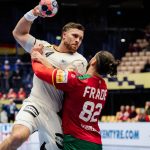 Germany's pivot #04 Johannes Golla and Portugal's pivot #82 Luis Frade vie during the men's EHF Euro 2026 main round handball match Germany vs Portugal in Herning, Denmark, on January 22, 2026.