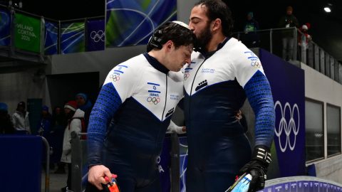 Israel's Adam Edelman and Israel's Menachem Chen congratulate each other after competing in the bobsleigh men's 2-man heat 3 at Cortina Sliding Centre during the Milano Cortina 2026 Winter Olympic Games in Cortina d'Ampezzo on February 17, 2026.
