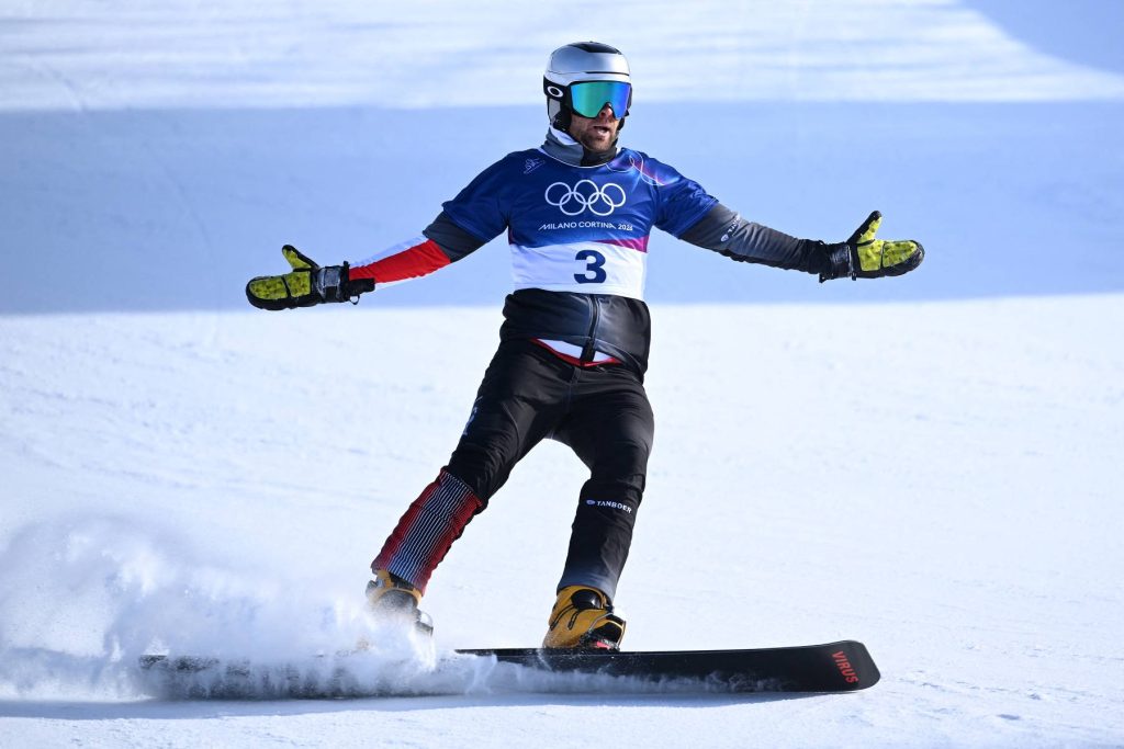 Austria's Benjamin Karl celebrates his victory in the snowboard men's parallel giant slalom final at Livigno Snow Park during the Milano Cortina 2026 Winter Olympic Games, in Livigno (Valtellina), on February 8, 2026.