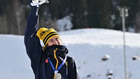 Silver medallist Sweden's Ebba Andersson celebrates on the podium for the women's cross country 10km + 10km skiathlon event of the Milano Cortina 2026 Winter Olympics at Tesero Cross-Country Skiing Stadium in Lago di Tesero (Val di Fiemme) on February 7, 2026.