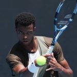 France’s Giovanni Mpetshi Perricard hits a return against Argentina’s Sebastian Baez during their men's singles match on day three of the Australian Open tennis tournament in Melbourne on January 20, 2026.