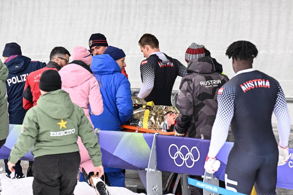 Rémisztő pillanat: felborult az osztrák négyes bob, hordágyon vitték el a pilótát 1 Austria's Jakob Mandlbauer is brought off on a stretcher after a crash in the bobsleigh men's 4-man heat 2 at Cortina Sliding Centre during the Milano Cortina 2026 Winter Olympic Games in Cortina d'Ampezzo on February 21, 2026.