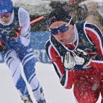 Finland's Eero Hirvonen (L) and Norway's Jens Luraas Oftebro compete in the cross-country of the nordic combined team sprint large hill event at Tesero Cross Country Stadium at Lago di Tesero (Val di Fiemme) during the Milano Cortina 2026 Winter Olympic Games on February 19, 2026.