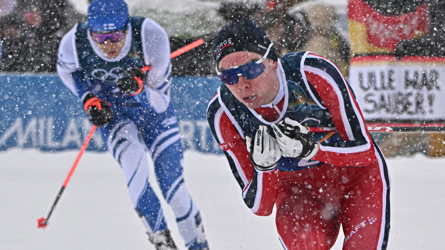 Finland's Eero Hirvonen (L) and Norway's Jens Luraas Oftebro compete in the cross-country of the nordic combined team sprint large hill event at Tesero Cross Country Stadium at Lago di Tesero (Val di Fiemme) during the Milano Cortina 2026 Winter Olympic Games on February 19, 2026.
