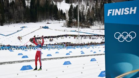 Norway's Johannes Hoesflot Klaebo celebrates as he crosses the finish line to win gold in the men's cross country 50km mass start final event of the Milano Cortina 2026 Winter Olympic Games at Tesero Cross-Country Skiing Stadium in Lago di Tesero (Val di Fiemme) on February 21, 2026.