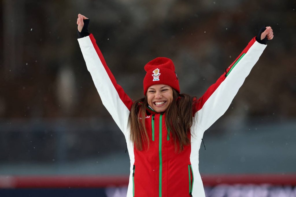 Bronze medallist Bulgaria's Lora Hristova celebrates on the podium of the women's biathlon 15km individual event during the Milano Cortina 2026 Winter Olympic Games at the Anterselva Biathlon Arena (Sudtirol Arena) in Anterselva (Val Pusteria) on February 11, 2026.