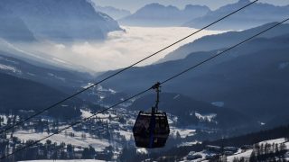 A photograph taken on February 21, 2021 shows a cable car surrounded by the Dolimiti mountains, in Cortina d'Ampezzo, Italian Alps.