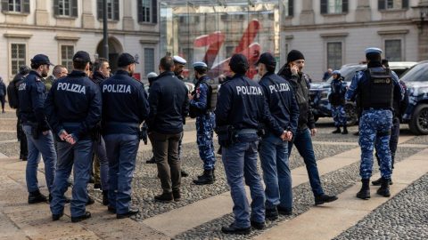 MILAN, ITALY - FEBRUARY 11: Police stands near Omega Countdown Clock on February 11, 2026 in Milan, Italy. During Winter Olympics Milano is hosting all ice sports, including figure skating, short track speed skating, skating and ice hockey matches events between February 6 and 22, 2026. (Photo by Maja Hitij/Getty Images)