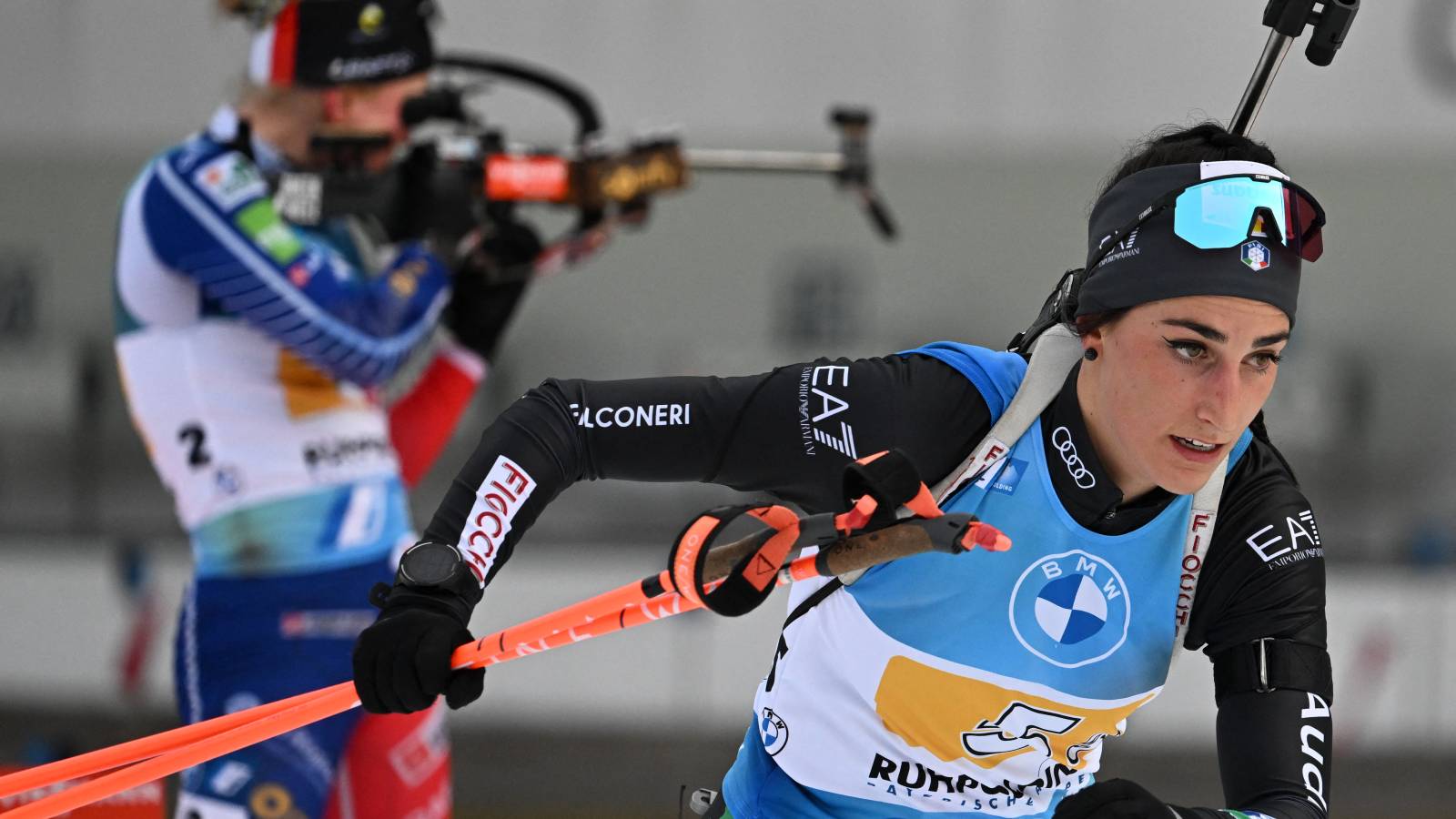 (FILES) Italy's Rebecca Passler (R) leaves the shooting range in front of France's Spohie Chauveau (L) during the Women's 4 x 6 km relay event of the IBU Biathlon World Cup in Ruhpolding, southern Germany, on January 14, 2023. Italian biathlete Rebecca Passler has failed a doping test ahead of the Milan-Cortina Winter Olympics, the Italian anti-doping agency said on February 2, 2026. Passler, 24, has been "provisionally suspended" after her sample showed the presence of letrozole, a prohibited substance used to treat breast cancer, the agency (NADO Italia) said in a statement.