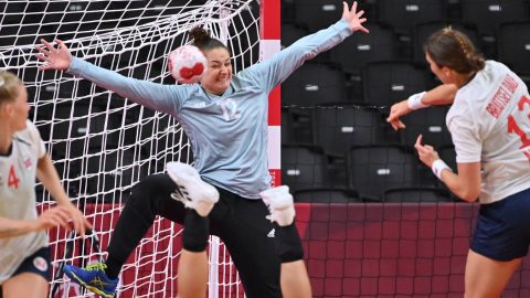 Hungary's goalkeeper Melinda Szikora (L) tries to stop a shot during the women's quarterfinal handball match between Norway and Hungary of the Tokyo 2020 Olympic Games at the Yoyogi National Stadium in Tokyo on August 4, 2021.