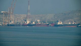 Tankers are seen at the Khor Fakkan Container Terminal, the only natural deep-sea port in the region and one of the major container ports in the Sharjah Emirate, along the Strait of Hormuz, a waterway through which one-fifth of global oil output passes on June 23, 2025. (Photo by Giuseppe CACACE / AFP)