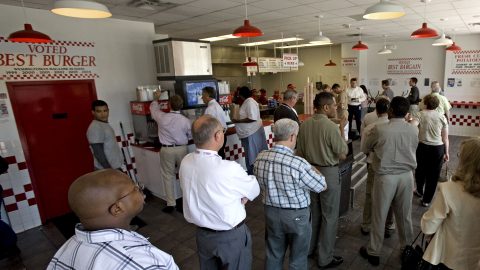 TO GO WITH AFP STORY-US-FOOD-RETAIL-COMPANY: Customers wait in line to place their food order at the Five Guys Famous Burgers and Fries restaurant at one of their newest stores 21 June 2007 on New Jersey Ave, in Washington, DC. Five Guys restaurant sells about 1500-to-2000 of the all fresh, completely handmade burgers made anyway your want each day. America's hundred-billion-dollar fast-food market is already crowded and battling to retain health-conscious customers, but one company has people lining up to feast on its hamburgers and fries. AFP PHOTO/Paul J. Richards (Photo by PAUL J. RICHARDS / AFP)