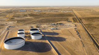 PECOS, TEXAS - MARCH 17: In an aerial view, oil storage tanks are seen in a field on March 17, 2026 in Pecos, Texas. Oil prices have risen roughly 4% as the recent conflict involving Iran, the United States, and Israeli forces heightens global concerns over energy costs. Attacks on energy infrastructure and shipping disruptions through the Strait of Hormuz—a critical passage responsible for about 20% of the world’s oil supply—are intensifying fears of supply shortages and rising inflation, as production and exports across the region continue to be disrupted. Brandon Bell/Getty Images/AFP (Photo by Brandon Bell / GETTY IMAGES NORTH AMERICA / Getty Images via AFP)