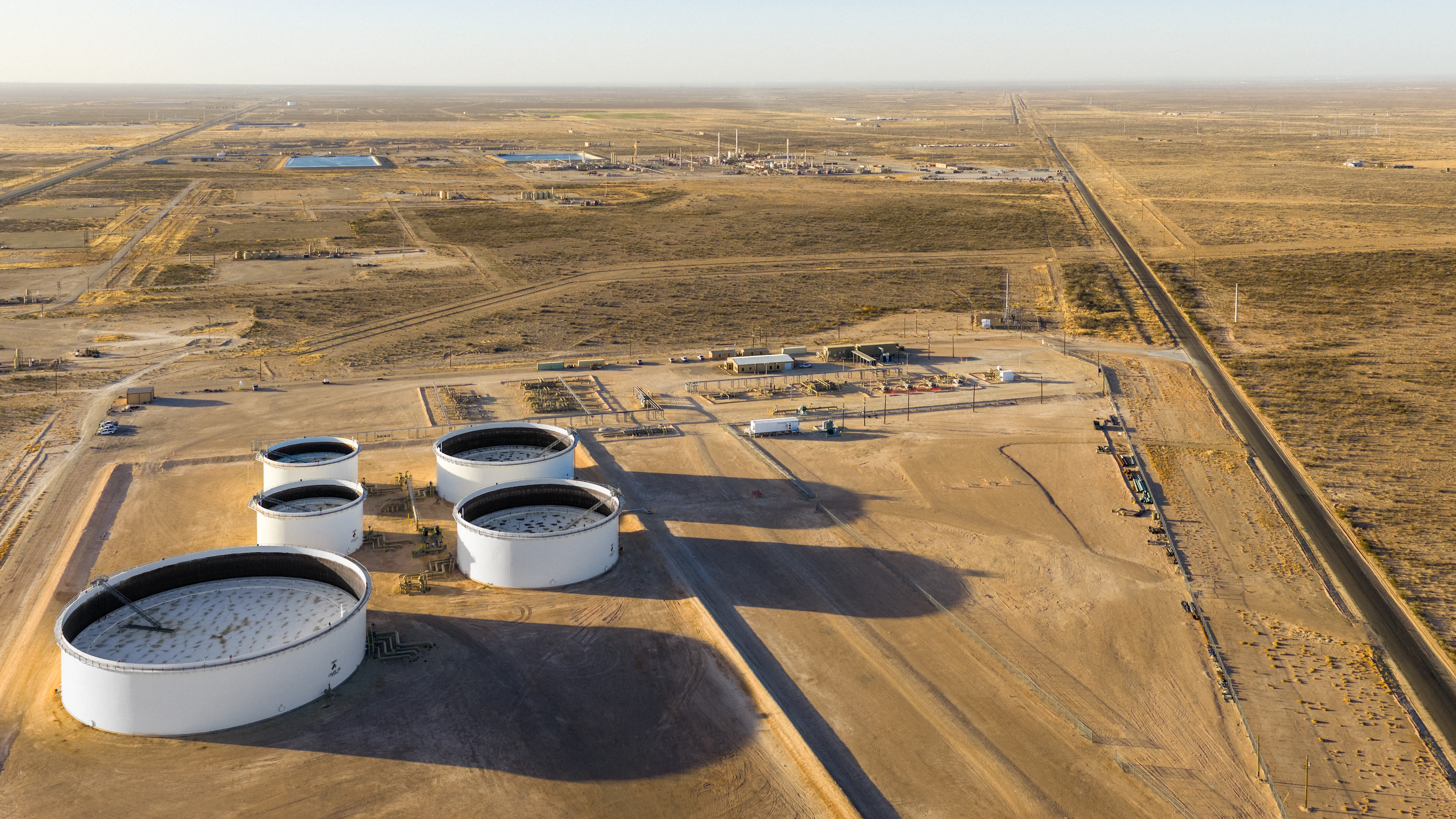 PECOS, TEXAS - MARCH 17: In an aerial view, oil storage tanks are seen in a field on March 17, 2026 in Pecos, Texas. Oil prices have risen roughly 4% as the recent conflict involving Iran, the United States, and Israeli forces heightens global concerns over energy costs. Attacks on energy infrastructure and shipping disruptions through the Strait of Hormuz—a critical passage responsible for about 20% of the world’s oil supply—are intensifying fears of supply shortages and rising inflation, as production and exports across the region continue to be disrupted. Brandon Bell/Getty Images/AFP (Photo by Brandon Bell / GETTY IMAGES NORTH AMERICA / Getty Images via AFP)