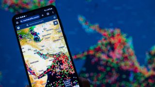 A MarineTraffic map showing ship movements in the Strait of Hormuz is displayed on a smartphone screen with a map in the background in this photo illustration, as commercial vessel traffic through the key oil shipping lane decreases amid the ongoing conflict involving Iran. Taken in Brussels, Belgium, on March 15, 2026. (Photo by Jonathan Raa/NurPhoto) (Photo by Jonathan Raa / NurPhoto via AFP)