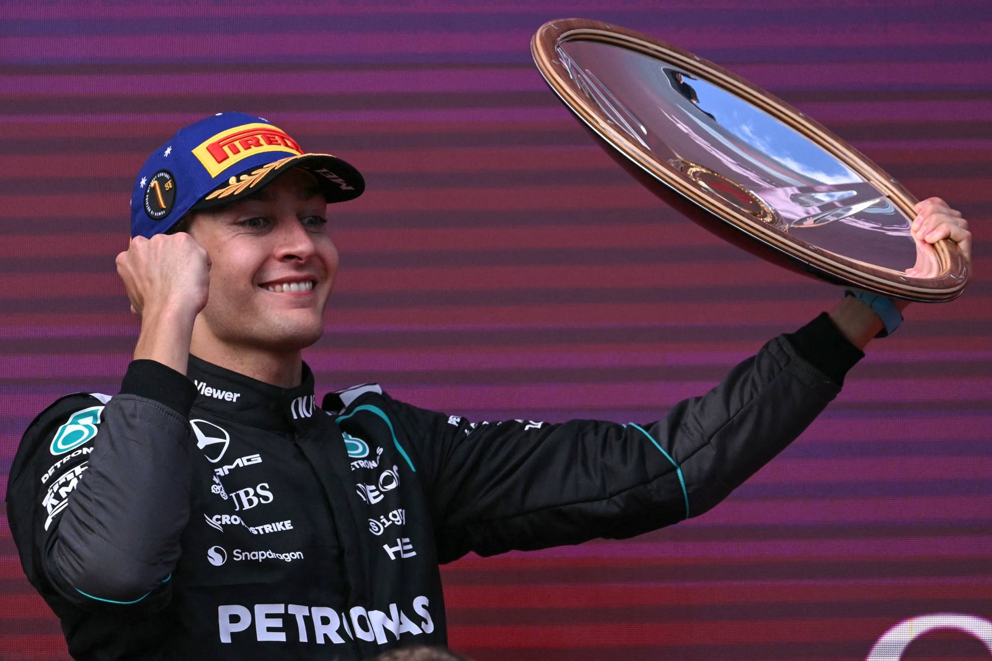 Mercedes' British driver George Russell celebrates on the podium after winning the Formula One Australian Grand Prix at the Albert Park Circuit in Melbourne on March 8, 2026.