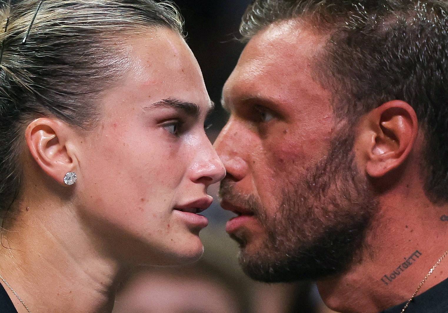 Belarus’ Aryna Sabalenka (L) and her partner Georgios Frangulis look on after the Battle of the Sexes exhibition tennis match against Australia's Nick Kyrgios in Dubai on December 28, 2025.
