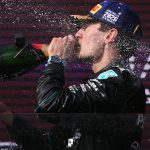 driver George Russell drinks champagne as he celebrates on the podium after winning the Formula One Australian Grand Prix at the Albert Park Circuit in Melbourne on March 8, 2026.