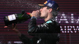 driver George Russell drinks champagne as he celebrates on the podium after winning the Formula One Australian Grand Prix at the Albert Park Circuit in Melbourne on March 8, 2026.