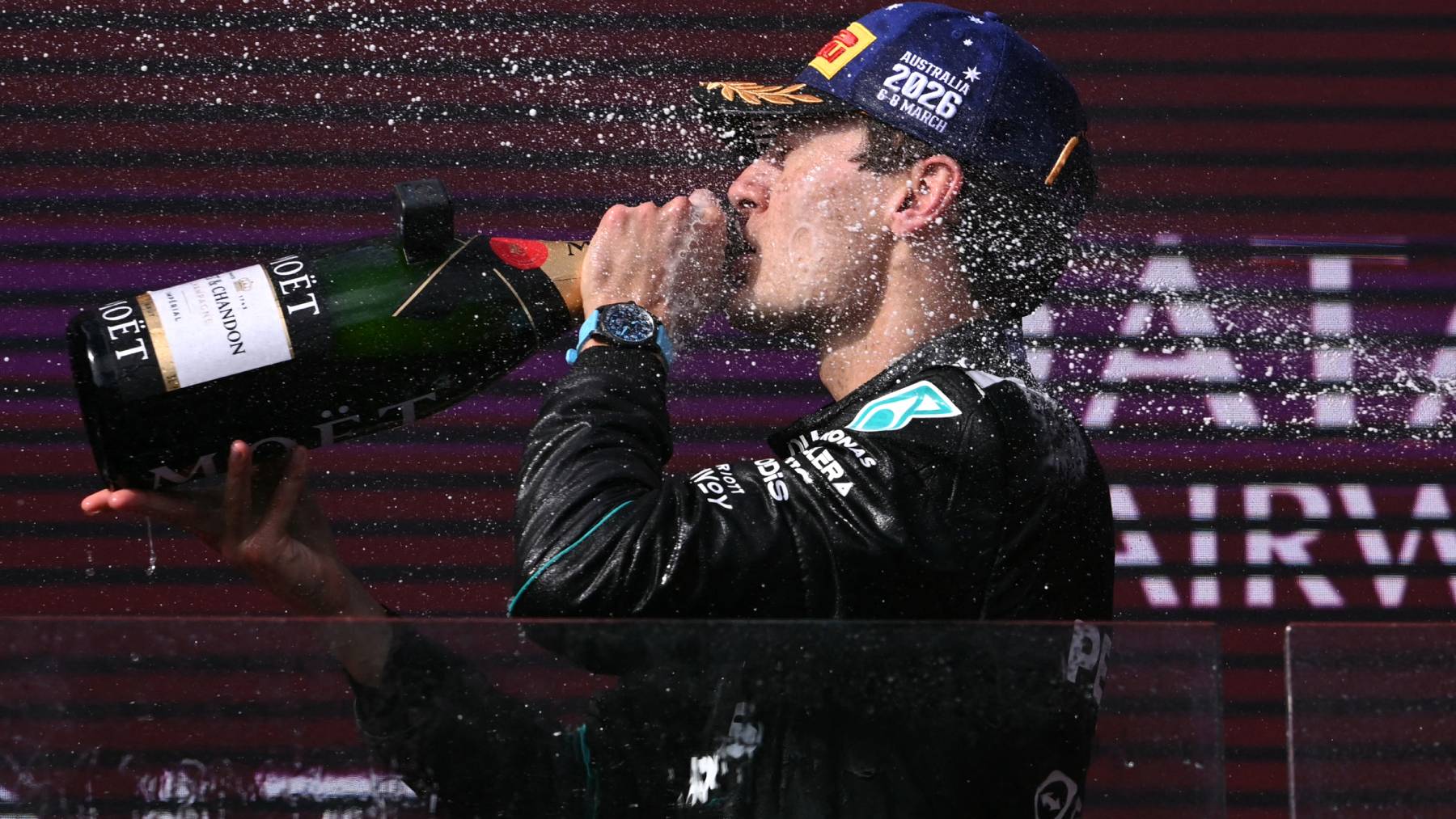 driver George Russell drinks champagne as he celebrates on the podium after winning the Formula One Australian Grand Prix at the Albert Park Circuit in Melbourne on March 8, 2026.