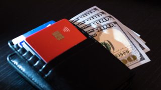 Wallet with 100-dollar bank notes and credit/debit cards