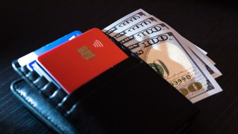 Wallet with 100-dollar bank notes and credit/debit cards