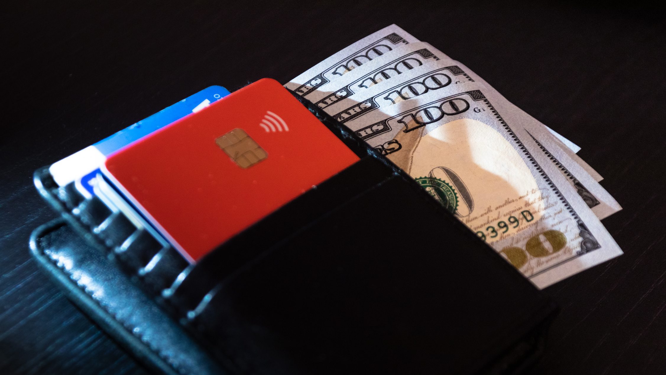 Wallet with 100-dollar bank notes and credit/debit cards