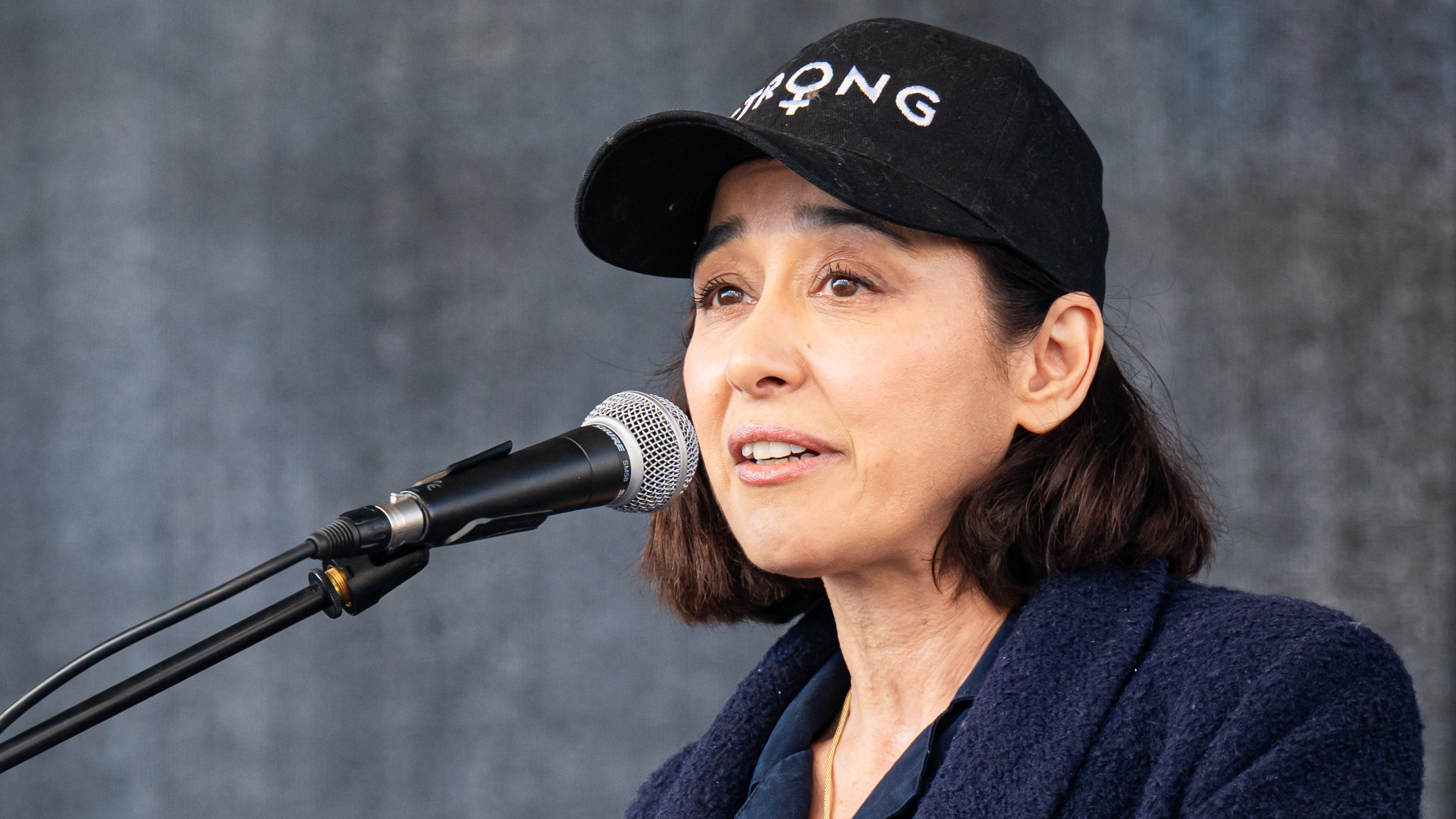 Gryllus Dorka a mikrofonba beszél egy színpadon a Parlament előtt