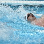 US' Hunter Armstrong competes in a heat of the men's 100m backstroke swimming event during the Paris 2024 Olympic Games at the Paris La Defense Arena in Nanterre, west of Paris, on July 28, 2024.