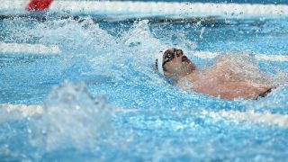 US' Hunter Armstrong competes in a heat of the men's 100m backstroke swimming event during the Paris 2024 Olympic Games at the Paris La Defense Arena in Nanterre, west of Paris, on July 28, 2024.