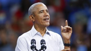 Former US President Barack Obama gestures as he speaks at a campaign rally with Minnesota Governor and Democratic vice presidential candidate Tim Walz in support of Vice President and Democratic presidential candidate Kamala Harris at Alliant Center in Madison, Wisconsin, on October 22, 2024. (Photo by KAMIL KRZACZYNSKI / AFP)