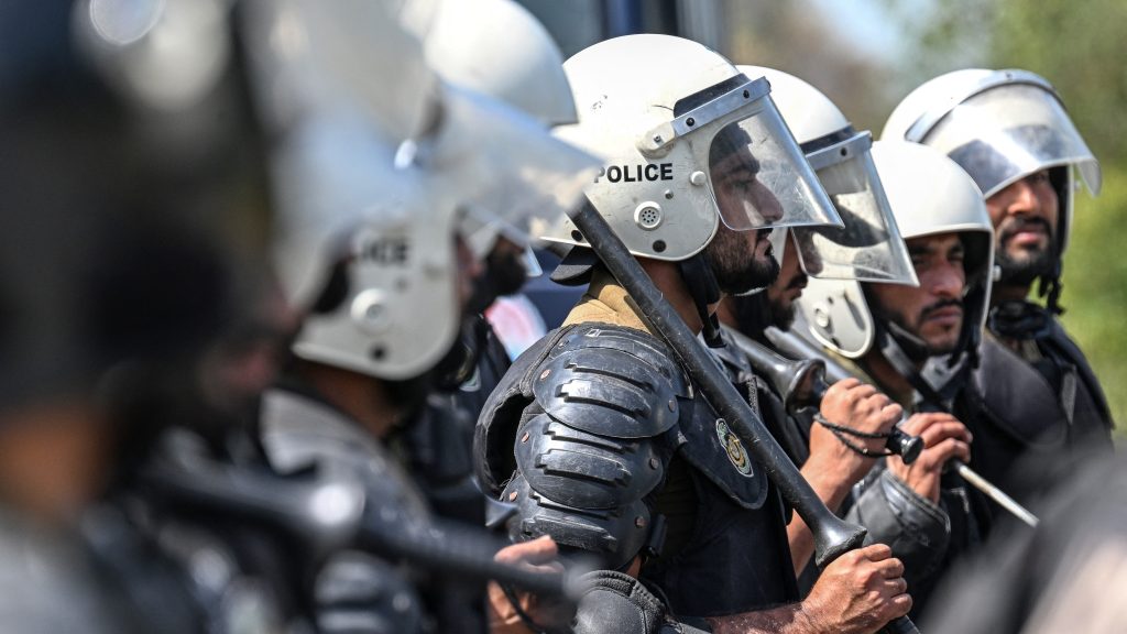 Riot policemen line up along a road near the expected venue of the US-Iran talks in the Red Zone area of Islamabad on April 10, 2026. As Iranian and US envoys prepare to hold talks in Islamabad to end the Middle East war, official sources and experts say Beijing helped pave the way for the negotiations and will be a crucial component in securing a permanent truce. (Photo by Aamir QURESHI / AFP)