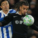 Chelsea's French defender #27 Malo Gusto (R) vies with Brighton's Japanese midfielder #22 Kaoru Mitoma (L) during the English Premier League football match between Brighton and Hove Albion and Chelsea at the American Express Community Stadium in Brighton, southern England on April 21, 2026.