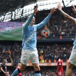 Manchester City's Norwegian striker #09 Erling Haaland (C) celebrates with Manchester City's English midfielder #33 Nico O'Reilly (R) after scoring their fourth goal during the English FA Cup quarter final football match between Manchester City and Liverpool at the Etihad Stadium in Manchester, north west England, on April 4, 2026.