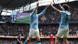 Manchester City's Norwegian striker #09 Erling Haaland (C) celebrates with Manchester City's English midfielder #33 Nico O'Reilly (R) after scoring their fourth goal during the English FA Cup quarter final football match between Manchester City and Liverpool at the Etihad Stadium in Manchester, north west England, on April 4, 2026.