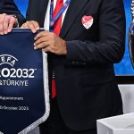 President of the Turkish Football Federation (TFF) Mehmet Buyukeksi (R) and UEFA president Aleksander Ceferin (L) holds the pennant after Turkey and Italy were elected to host the Euro 2032 fooball tournament during the announcement ceremony at the UEFA headquarters in Nyon on October 10, 2023.