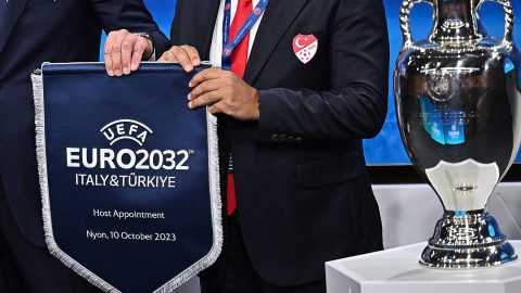 President of the Turkish Football Federation (TFF) Mehmet Buyukeksi (R) and UEFA president Aleksander Ceferin (L) holds the pennant after Turkey and Italy were elected to host the Euro 2032 fooball tournament during the announcement ceremony at the UEFA headquarters in Nyon on October 10, 2023.