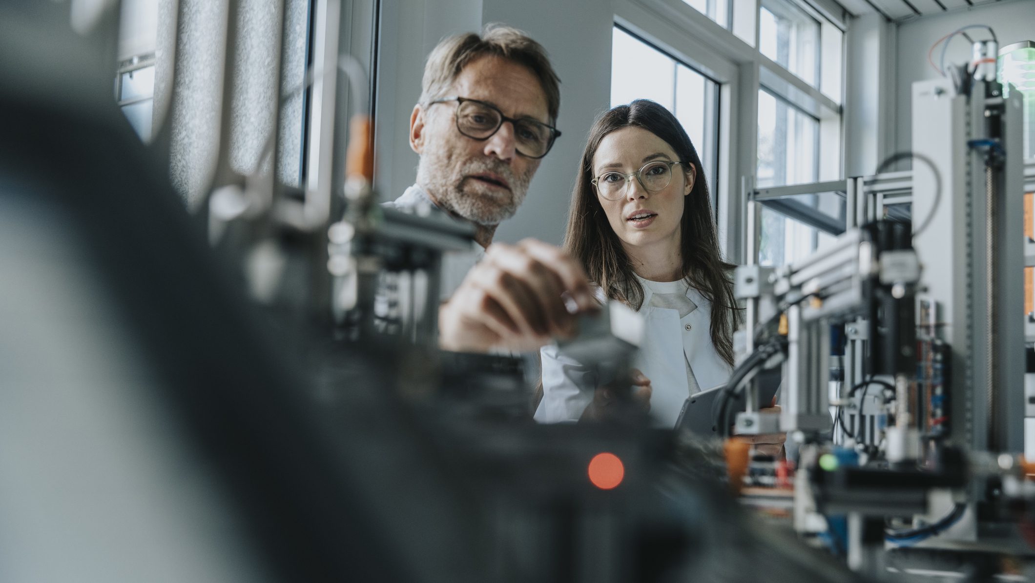 Two scientists in machine engineering lab