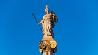 This is a photo of a statue of ancient Greek goddess Athena at sunset. The statue was designed by Greek sculptor Leonidas Drosis as part of the building of the Academy of Sciences in Athens, Greece in 1873.