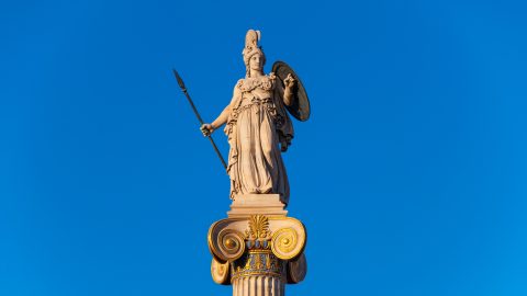 This is a photo of a statue of ancient Greek goddess Athena at sunset. The statue was designed by Greek sculptor Leonidas Drosis as part of the building of the Academy of Sciences in Athens, Greece in 1873.