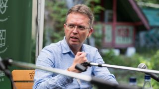 Hankó Balázs a mikrofonba beszél a Tusványos Fesztivál egyik színpadán.