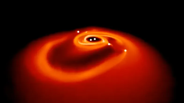 Képernyőkép egy kettős csillag körüli korong szimulációjából, amely gravitációs instabilitásba kerül, szétesik, és bolygókat képez