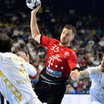 Kiel's Domagoj Duvnjak (L) and Kiel's Pavel Horak (R) block Veszprem's Kentin Mahe (C) during the EHF Men's Champions League Final Four third place handball match THW Kiel vs Telekom Veszprem HC in Cologne, western Germany on June 19, 2022.