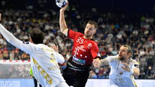 Kiel's Domagoj Duvnjak (L) and Kiel's Pavel Horak (R) block Veszprem's Kentin Mahe (C) during the EHF Men's Champions League Final Four third place handball match THW Kiel vs Telekom Veszprem HC in Cologne, western Germany on June 19, 2022.
