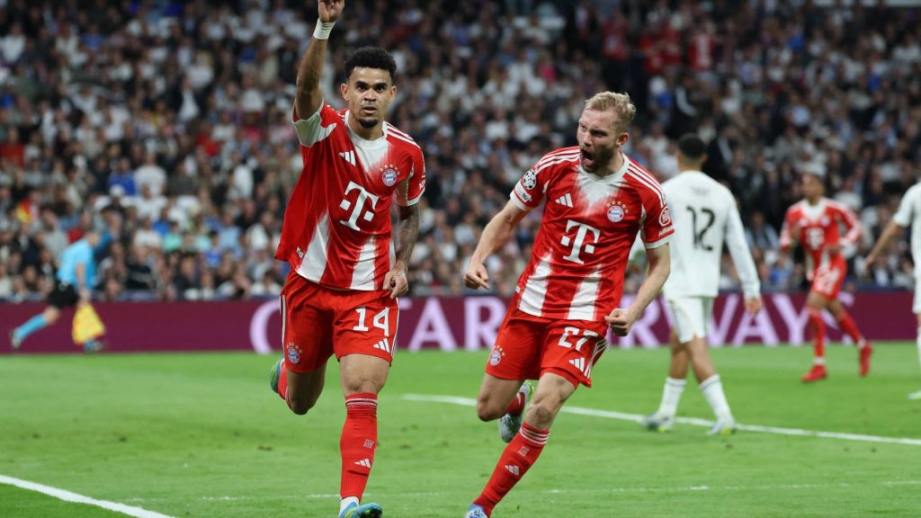 Bayern Munich's Colombian forward #14 Luis Diaz celebrates scoring the opening goal with Bayern Munich's Austrian midfielder #27 Konrad Laimer (R) during the UEFA Champions League quarter final first leg football match between Real Madrid CF and FC Bayern Munich at Santiago Bernabeu Stadium in Madrid on April 7, 2026.