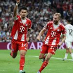 Bayern Munich's Colombian forward #14 Luis Diaz celebrates scoring the opening goal with Bayern Munich's Austrian midfielder #27 Konrad Laimer (R) during the UEFA Champions League quarter final first leg football match between Real Madrid CF and FC Bayern Munich at Santiago Bernabeu Stadium in Madrid on April 7, 2026.