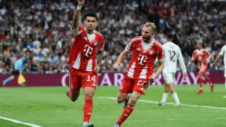 Bayern Munich's Colombian forward #14 Luis Diaz celebrates scoring the opening goal with Bayern Munich's Austrian midfielder #27 Konrad Laimer (R) during the UEFA Champions League quarter final first leg football match between Real Madrid CF and FC Bayern Munich at Santiago Bernabeu Stadium in Madrid on April 7, 2026.
